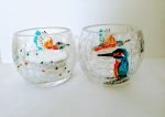 Two hand painted kingfisher candle holders with a crackle glaze