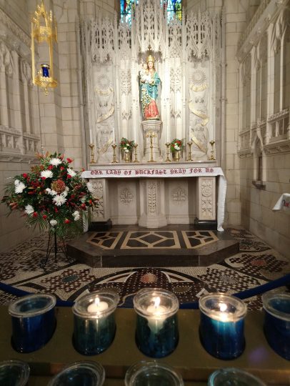 Buckfast Abbey altar with lighted candles in the foreground